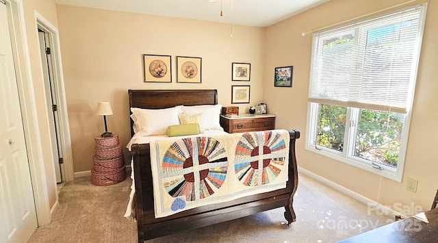 bedroom with baseboards, multiple windows, and light colored carpet