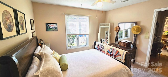 carpeted bedroom featuring ceiling fan and baseboards