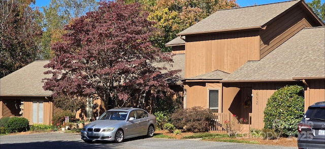 view of side of home featuring a shingled roof