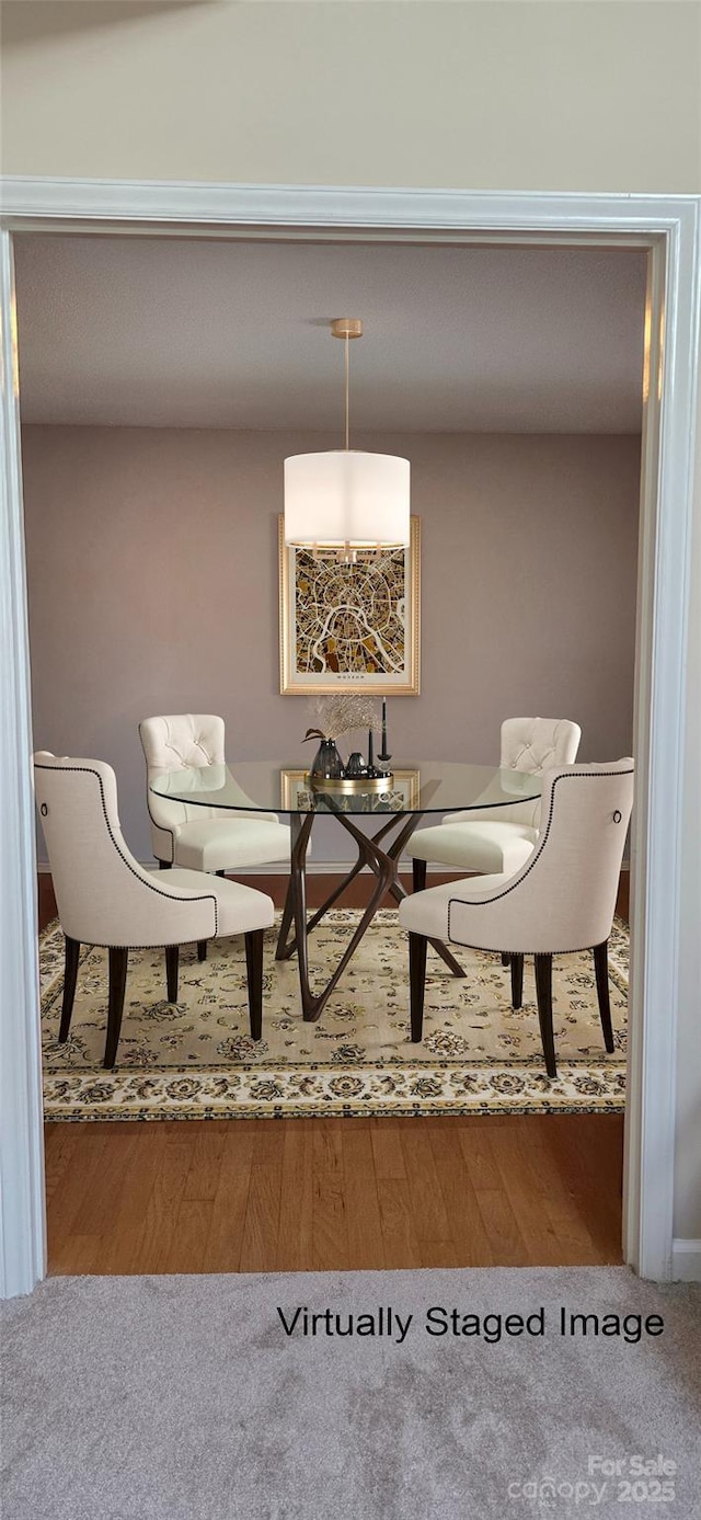 dining area with wood finished floors