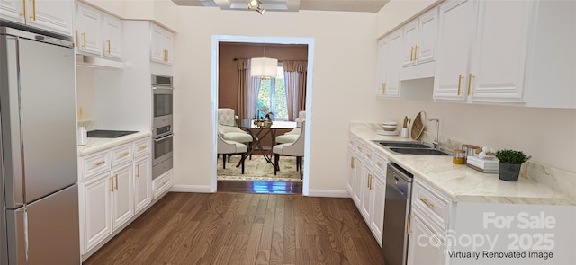 kitchen featuring stainless steel appliances, a sink, white cabinetry, baseboards, and dark wood-style floors