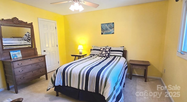 carpeted bedroom featuring a ceiling fan and baseboards