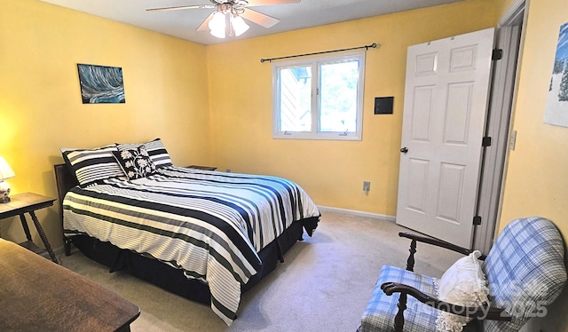 carpeted bedroom featuring ceiling fan and baseboards