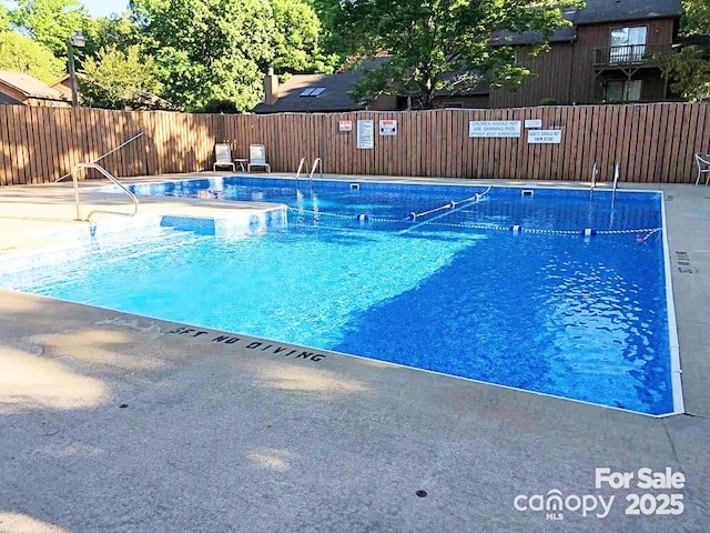 view of pool with fence