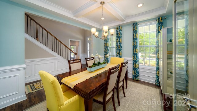 dining space featuring beam ceiling, ornamental molding, wood-type flooring, and an inviting chandelier