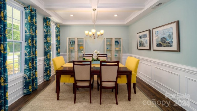 dining room featuring beam ceiling, coffered ceiling, hardwood / wood-style flooring, and plenty of natural light