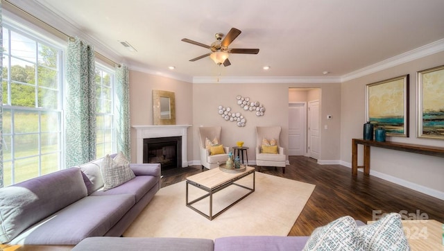 living room with ornamental molding, wood-type flooring, and ceiling fan