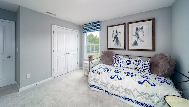 bedroom with light carpet and a closet