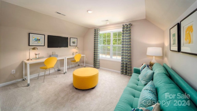 carpeted living room featuring vaulted ceiling