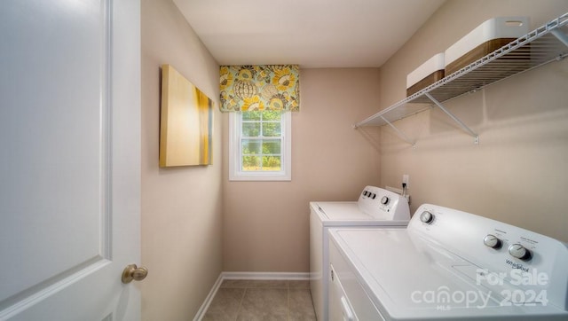 washroom with light tile patterned flooring and washing machine and clothes dryer