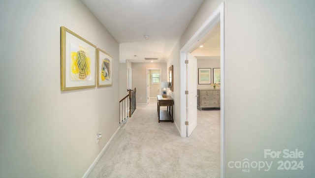 hallway with light colored carpet