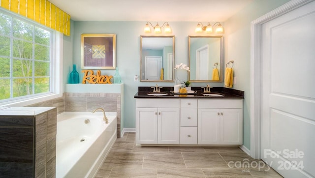 bathroom featuring vanity and a tub