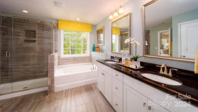 bathroom with vanity and plus walk in shower