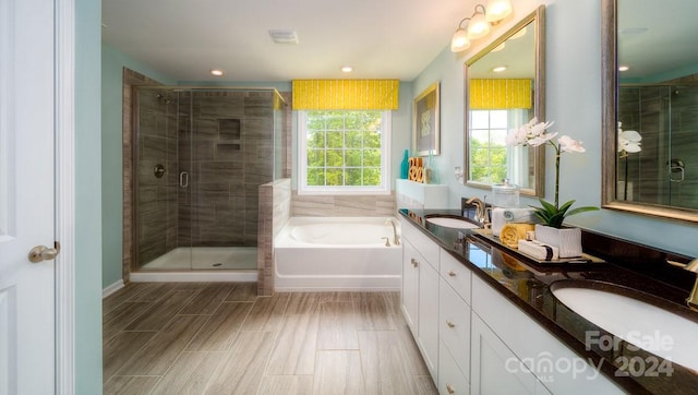 bathroom featuring vanity and shower with separate bathtub