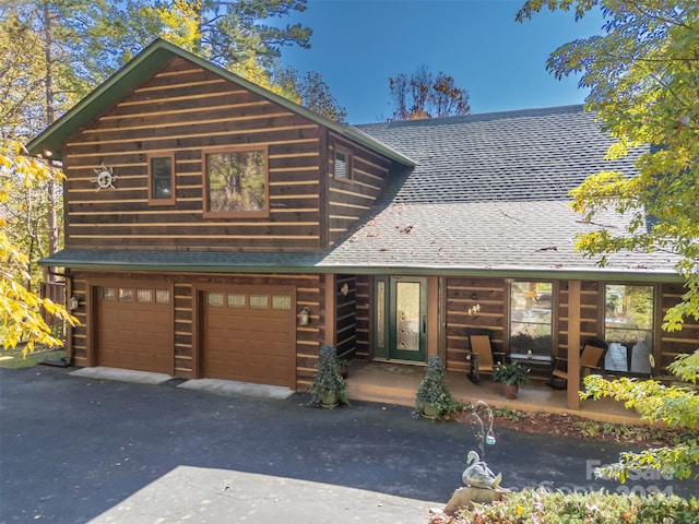 log home featuring a garage