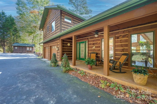 view of property exterior featuring a garage and ceiling fan