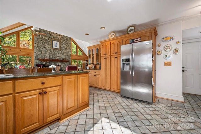 kitchen featuring stainless steel refrigerator with ice dispenser and light tile patterned floors