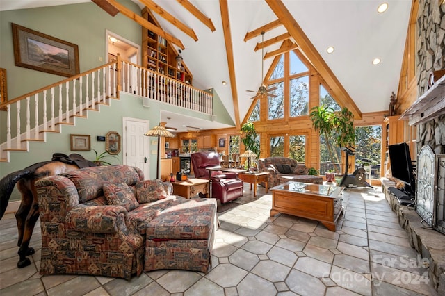 living room featuring beam ceiling, high vaulted ceiling, light tile patterned flooring, and a fireplace