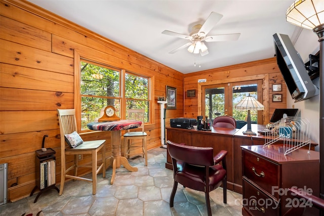 office space with french doors, ceiling fan, a wealth of natural light, and wooden walls