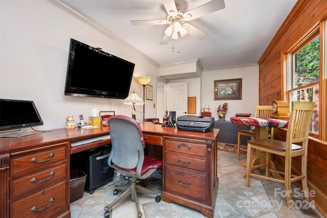 office space featuring wood walls, crown molding, and ceiling fan