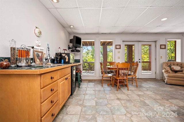 kitchen featuring french doors, sink, and a drop ceiling