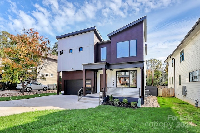 contemporary house with a garage and a front yard