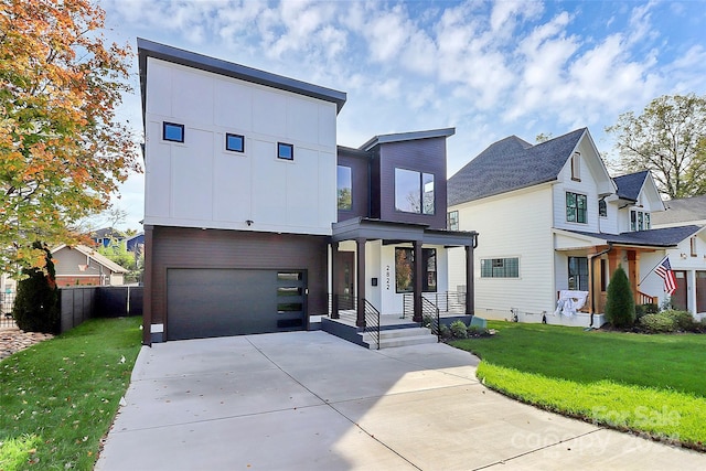 view of front of home with a garage and a front lawn