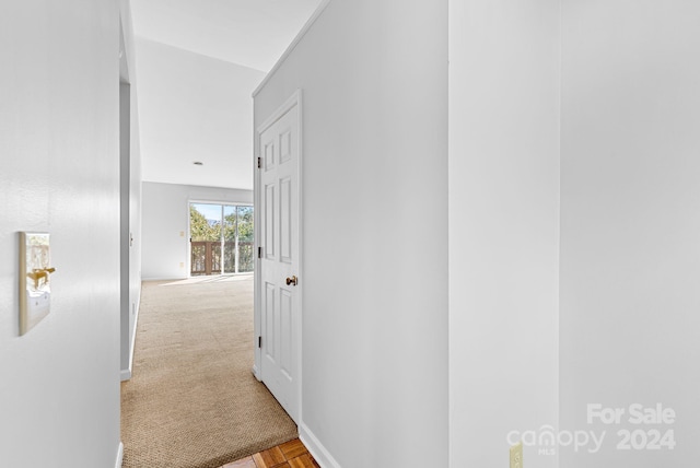 hall featuring light colored carpet