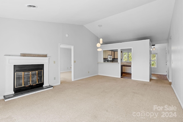 unfurnished living room with carpet floors and lofted ceiling