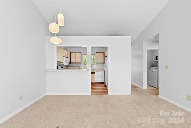 unfurnished living room featuring separate washer and dryer, light carpet, and vaulted ceiling