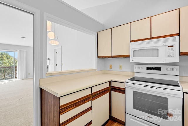 kitchen featuring light colored carpet and white appliances