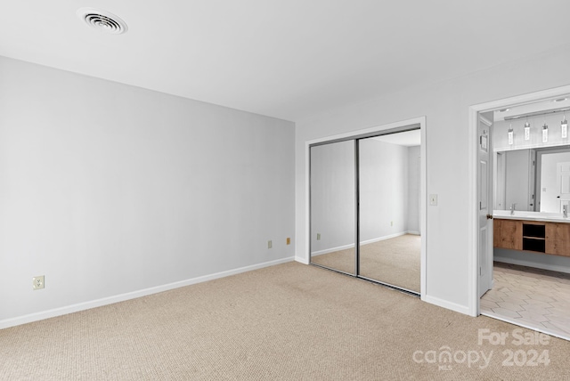 unfurnished bedroom featuring carpet and a closet