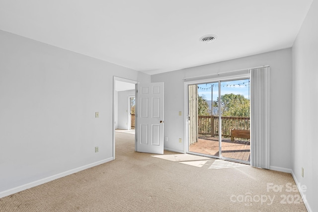 empty room featuring light colored carpet