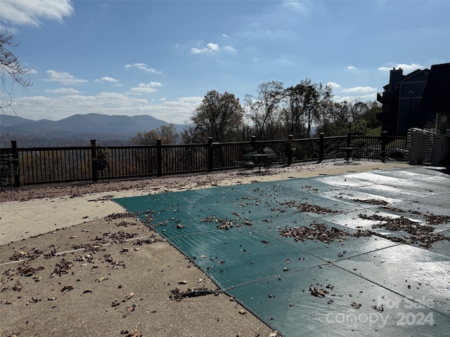 view of pool featuring a patio area and a mountain view