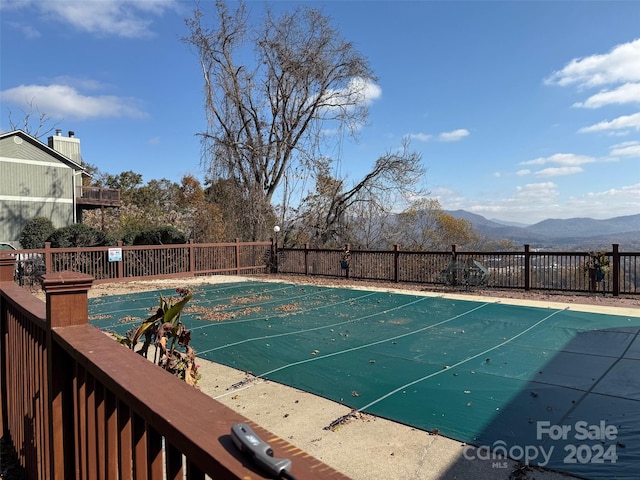 view of swimming pool with a mountain view