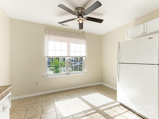 kitchen with white cabinets, ceiling fan, light tile patterned floors, and white appliances