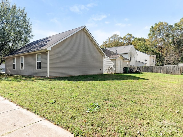 view of side of home featuring a lawn