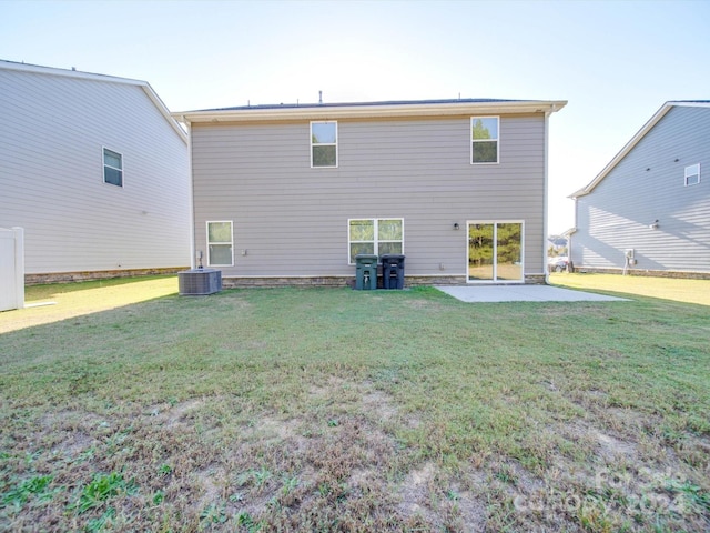 back of house with central AC unit, a yard, and a patio area