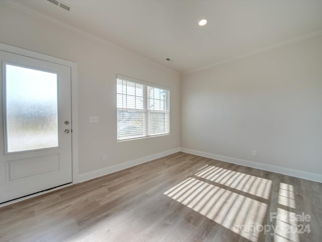 entrance foyer with light wood-type flooring and ornamental molding