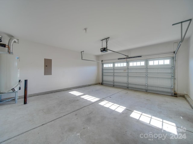 garage with electric panel, a garage door opener, and gas water heater