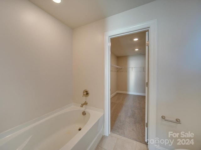 bathroom with a bathtub and tile patterned floors