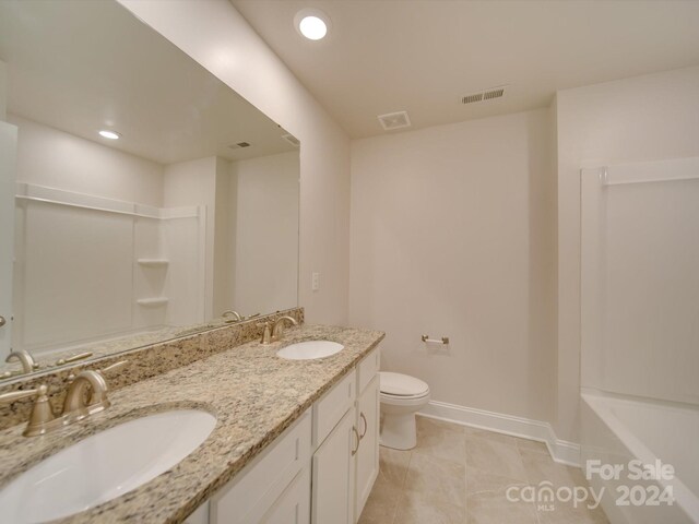 bathroom with tile patterned flooring, vanity, and toilet