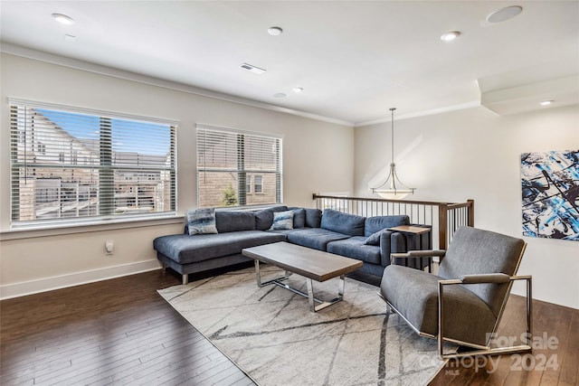 living room with crown molding and dark wood-type flooring