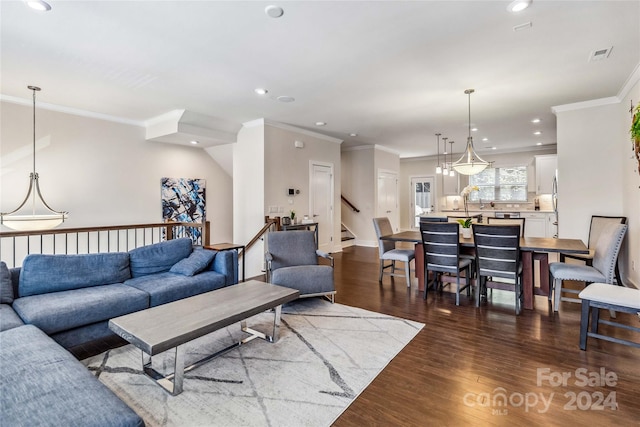 living room with ornamental molding and dark wood-type flooring