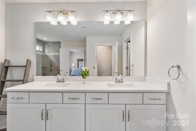 bathroom featuring vanity and a shower with door