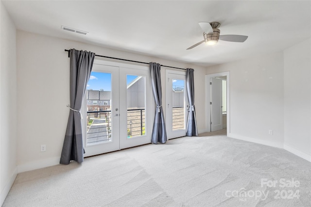 carpeted spare room with french doors and ceiling fan