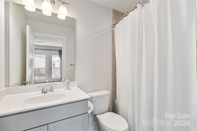 bathroom featuring vanity, toilet, and walk in shower