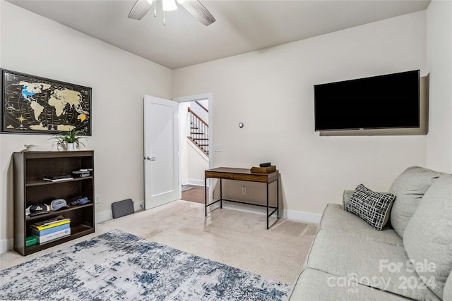 carpeted living room with ceiling fan