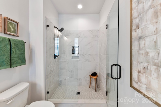 bathroom featuring toilet and walk in shower