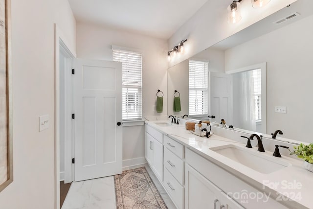 bathroom featuring a wealth of natural light and vanity